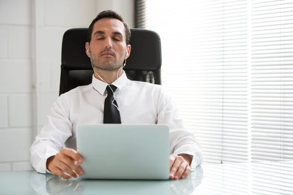 Half length portrait of a male businessman with eyes closed