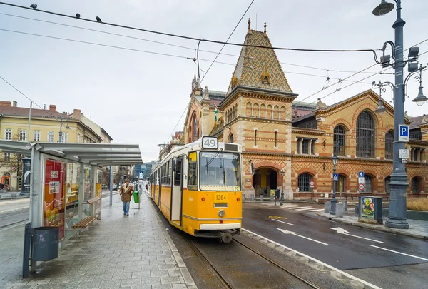 Yellow tram and Great Market Hall in Budapest, Hungary.