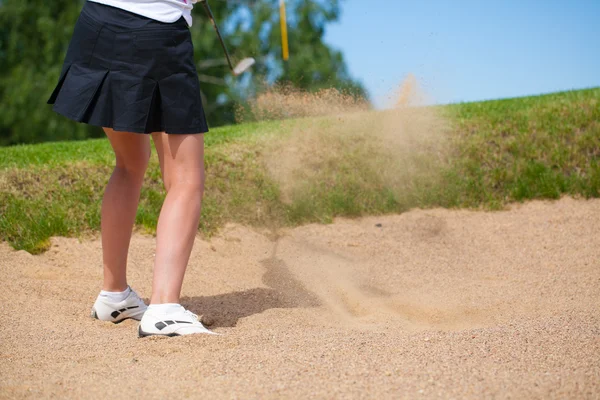 Golfer Hitting a Tee Shot in sand