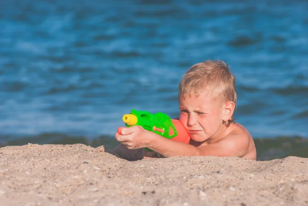 Little boy play with water gun 2