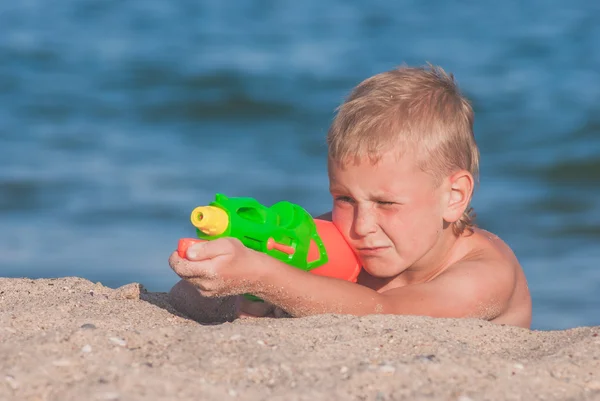 Little boy play with water gun 3