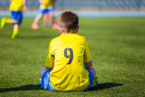 Young football soccer player in sportswear. Youth soccer football match for young boys.