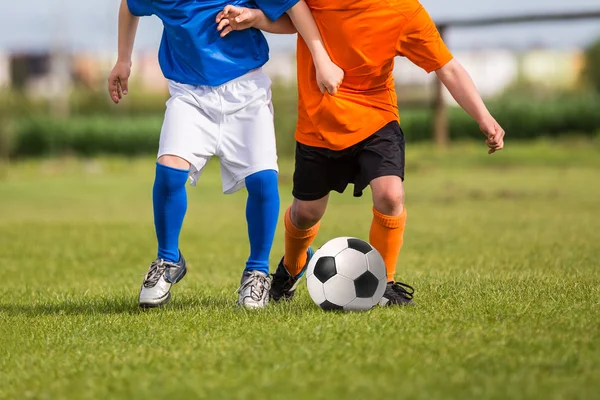 Children kicking soccer football ball