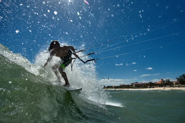 Kitesurfer riding the wave