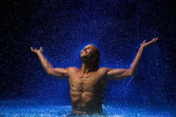 Man in water under rain