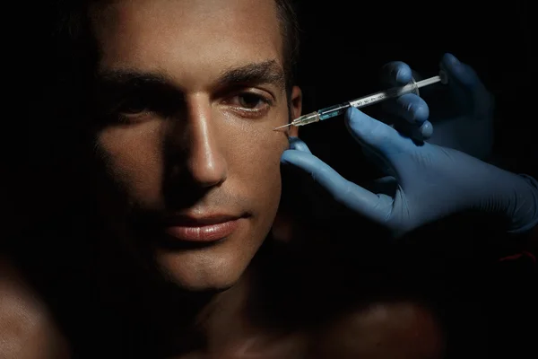 Man gets cosmetic injection.