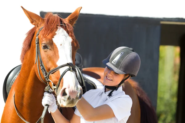 Female jockey with purebred horse