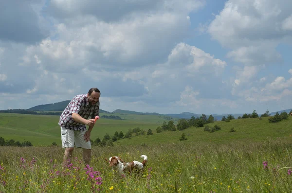 Man is Playing With His Dog