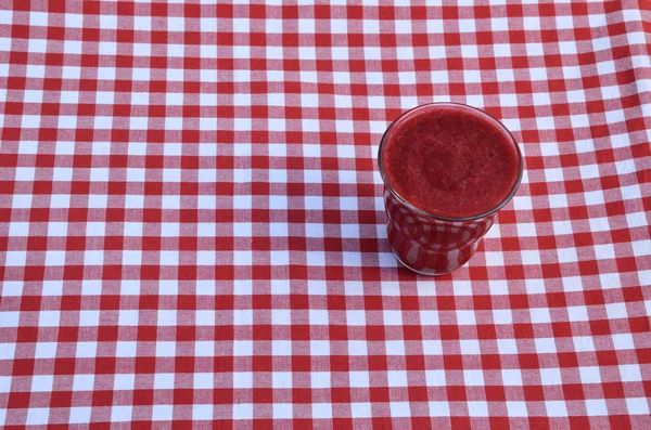 Raspberry smoothie on red-white