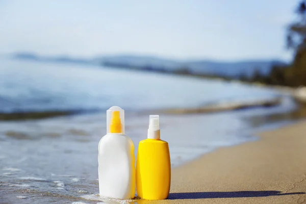 Close up image of two bottles of sunscreen lotion standing on a