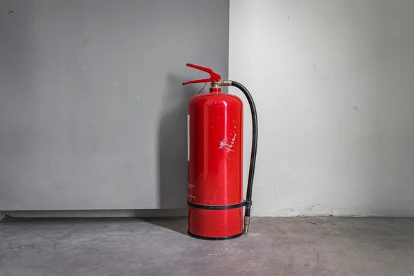 Fire extinguisher used to hold the door open.