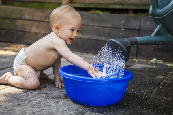 Adorable baby playing with water