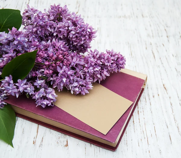 Lilac flowers and old book