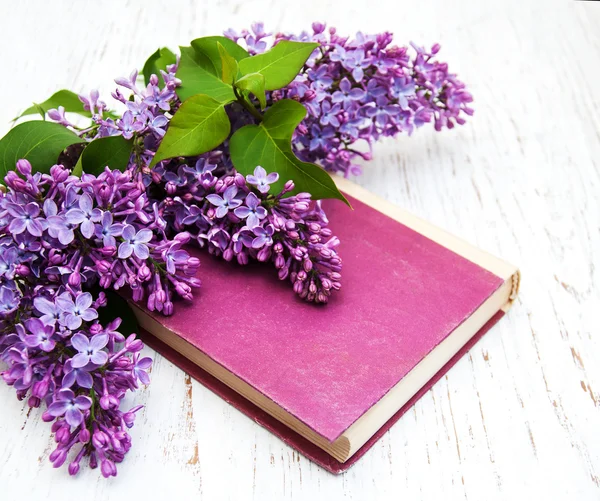 Lilac flowers and old book