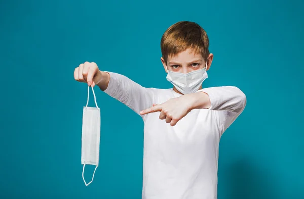 Boy wearing protection mask pointing on mask