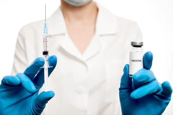 Medic holding syringe and capsule with vaccine in hand. Vaccination. Influenza