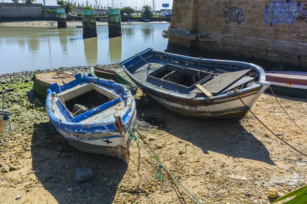 Old fishing boats on the shore of a river