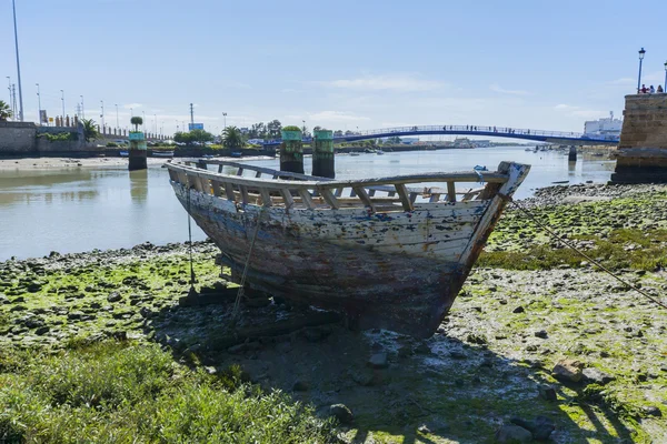 Old fishing boats on the shore of a river