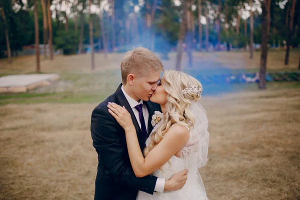 Wedding couple runs blue smoke