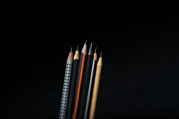 Six different black pencils
