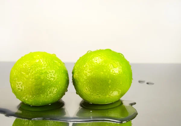 Two lime in water drops