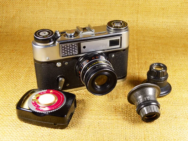 Old-fashioned photo-camera and accessories