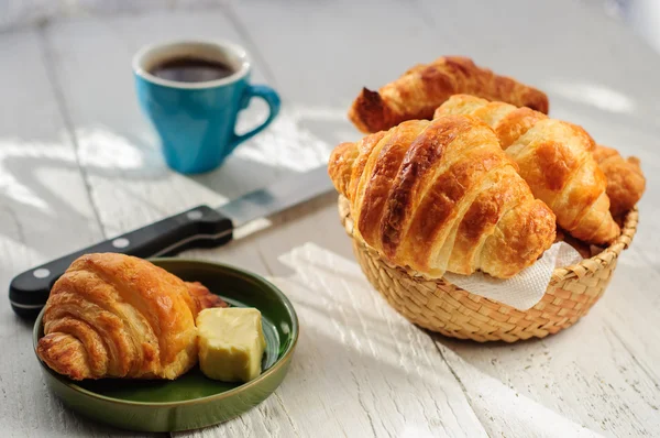 Breakfast with fresh baked croissants, butter and coffee