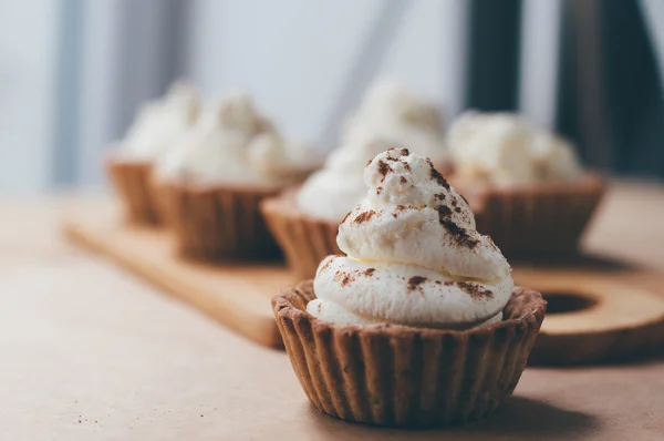 Little homemade oat tarts with whipped cream