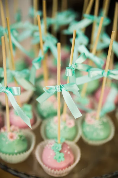 Wedding dessert with delicious cakes, macaroons and pop cakes