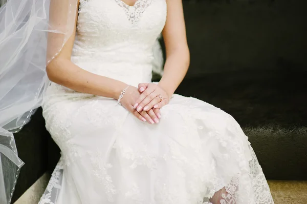 Bride getting dressed on her wedding day