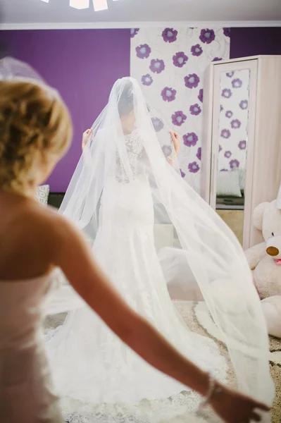 Bride getting dressed on her wedding day