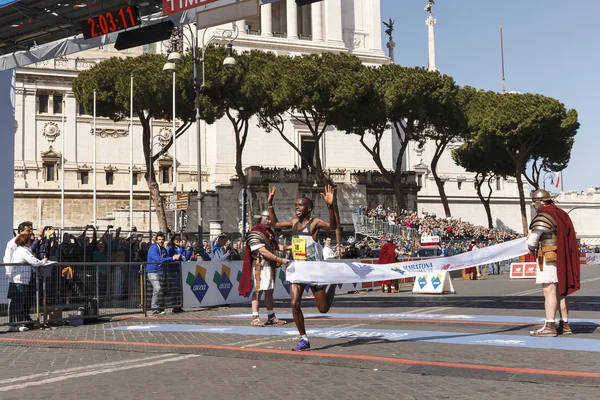 Amos Kipruto crosses the finish line