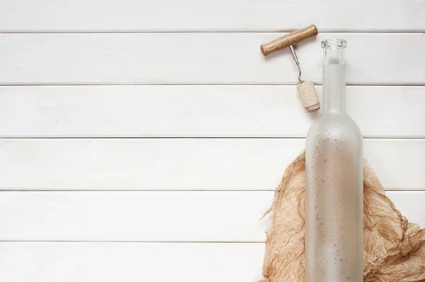 Empty wine bottle on the wooden background