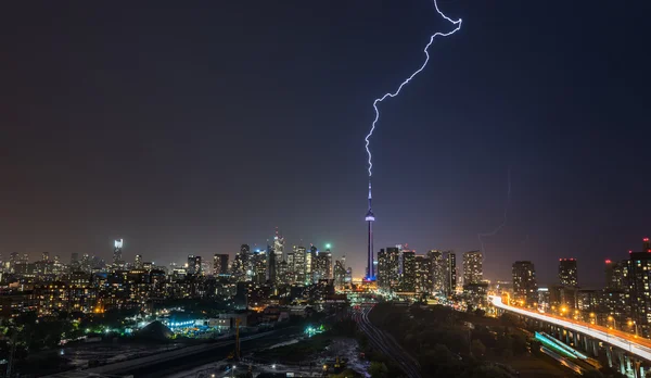 Lightning bolt strikes over Toronto City in a strong, hot, and humid thunderstorm.