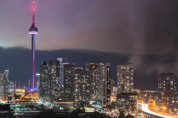 Cloud's edge cuts through hot humid night time air in Toronto, Canada.