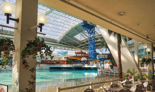 Indoor swimming pool and recreation center with cafe dinner tables & chairs