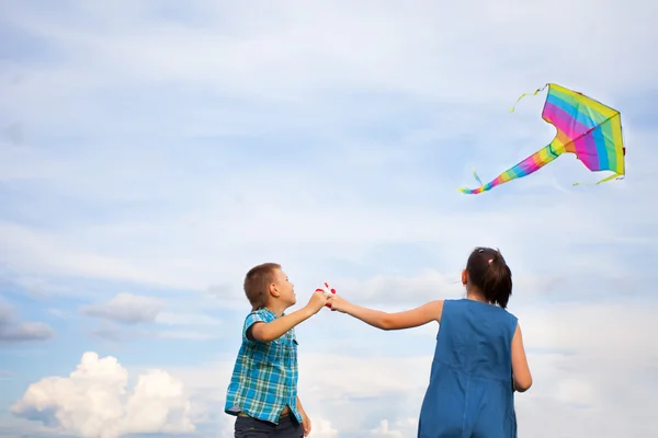 Boy and girl flying  kite