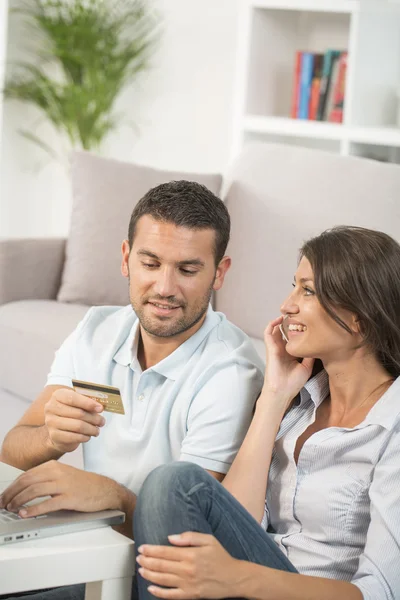 Couple using credit card to shop online