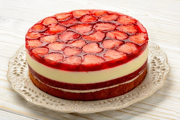 Delicious cheesecake with strawberry mousse, strawberry jelly and strawberries.
