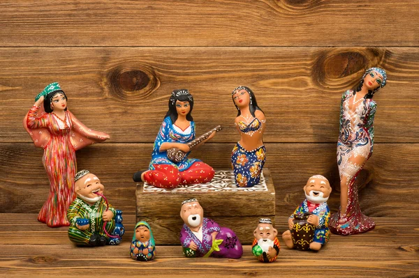 Uzbek ceramic souvenirs on the wooden background.