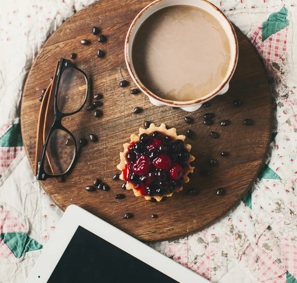 Cake with berries and coffee cup