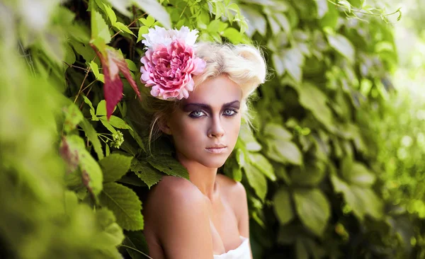 Gorgeous woman with flower in hair