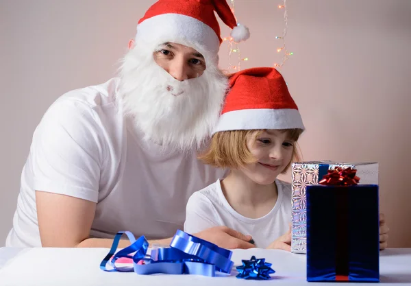 Little girl and father Christmas gift packs