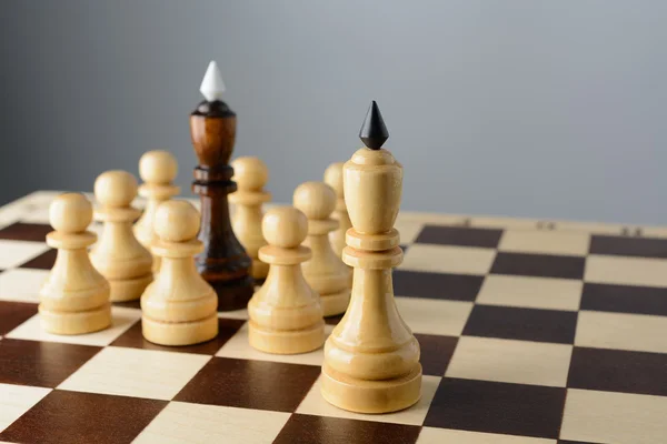 Black king surrounded by white pawns