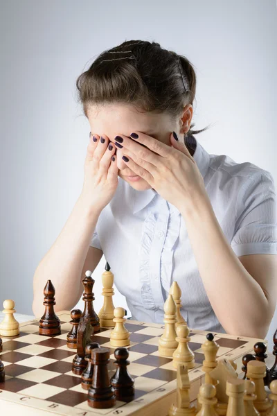 Business woman playing chess