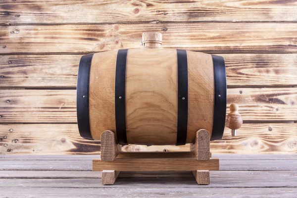 Wooden barrel on a wooden background