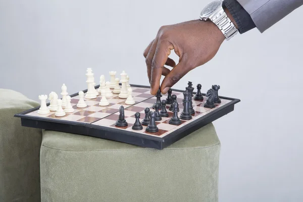 Male hand with wristwatch playing chess