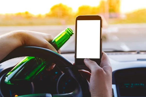 A man driving a car with a bottle of beer and phone