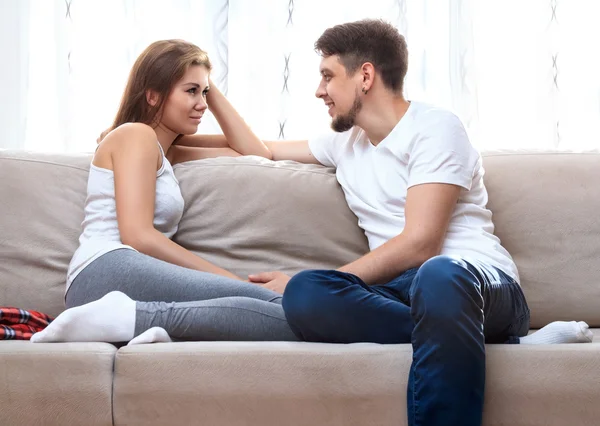 Couple sitting on sofa.