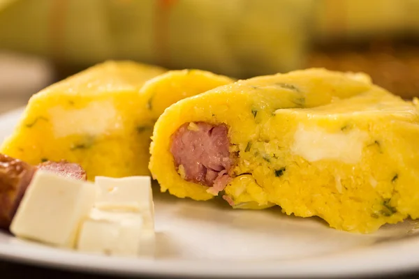 Salty Pamonha with sausage and cheese - typical food of green co